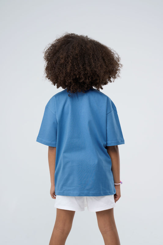 Young girl wearing a Sky Blue printed Oversized T-Shirt - Back View