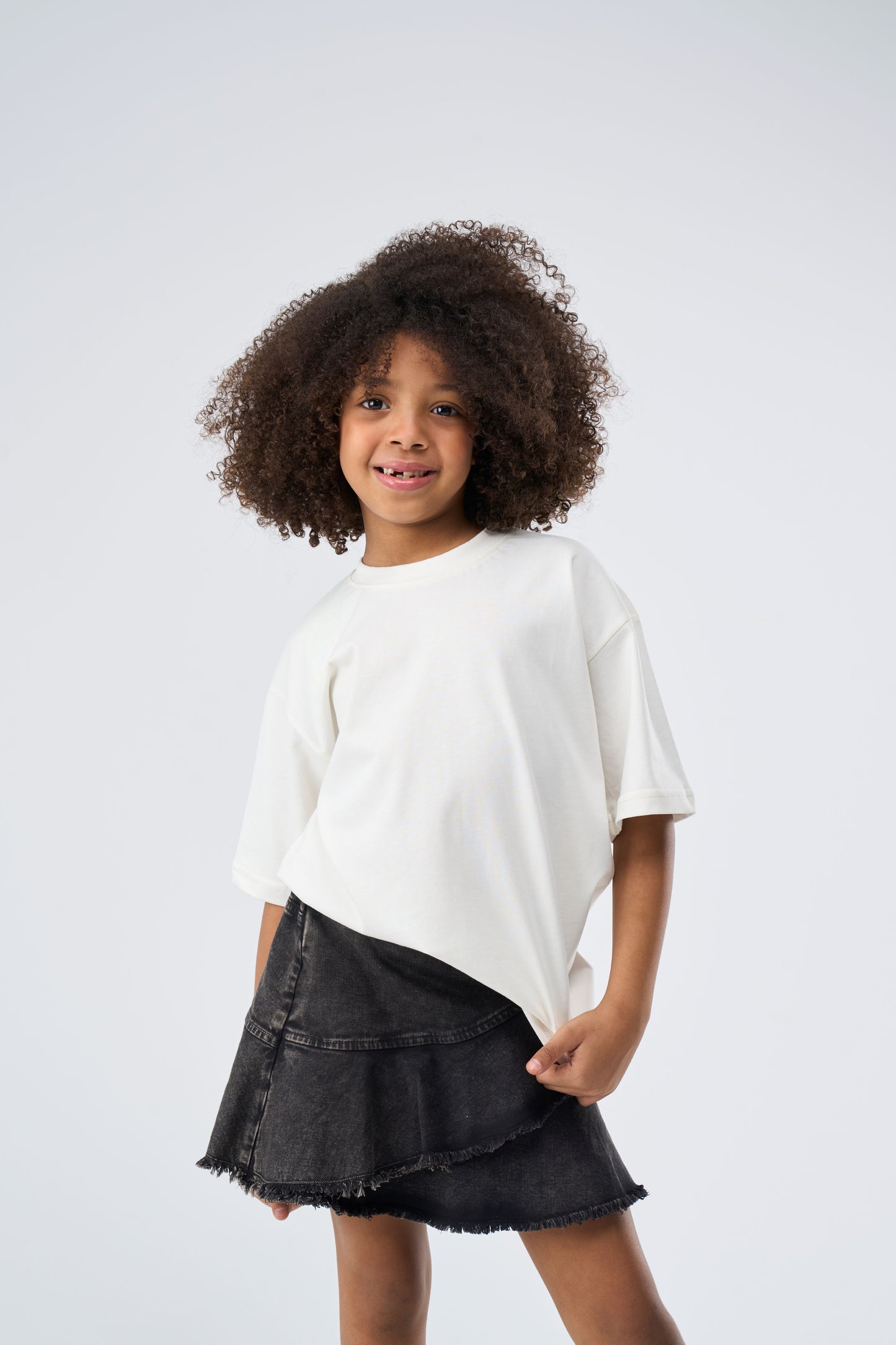 Young girl wearing an offwhite oversized t-shirt